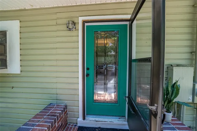 a view of a hallway with wooden floor fireplace and living room