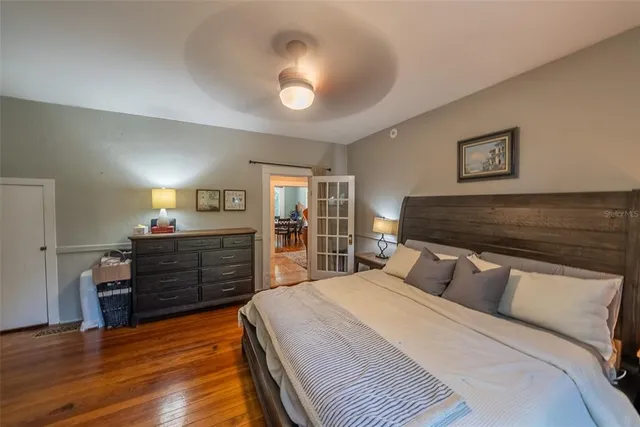 a bed sitting in a bedroom next to a window