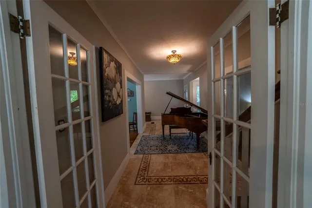 a view of a hallway with wooden floor