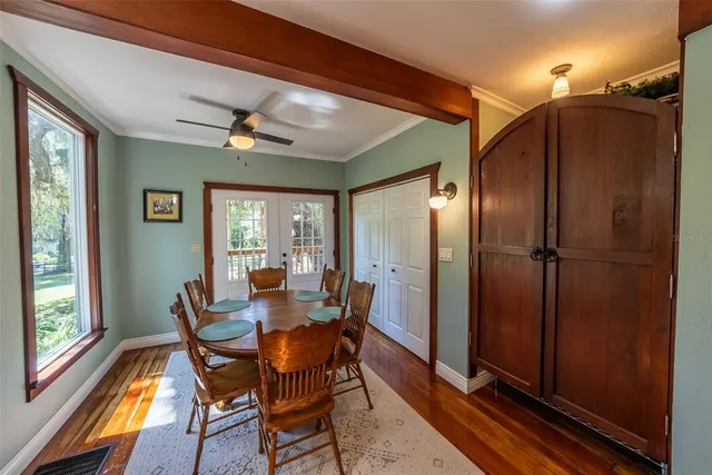 a living room with furniture a piano and a potted plant