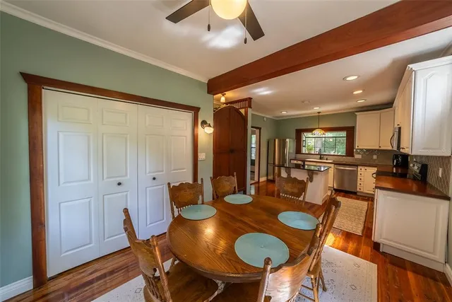 a view of a hallway with a livingroom and a bathroom with sink