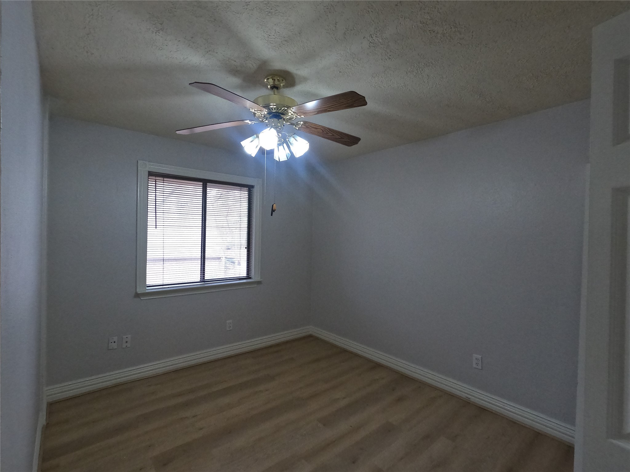 75 Willowwood Circle Spring, TX 77381 - Photo 13 of 14 an empty room with wooden floor fan and windows