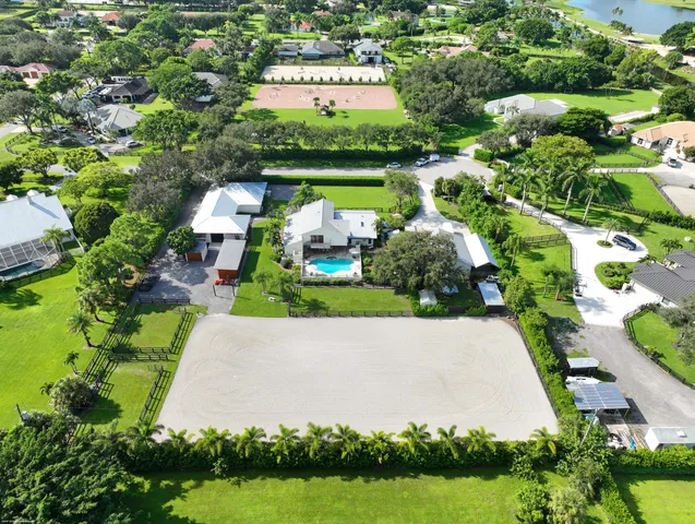 a view of a house with a yard and a large tree