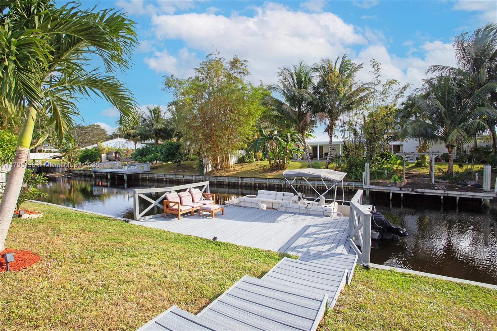 808 Mission Hill Road Boynton Beach, FL 33435 - Photo 11 of 68 a view of a swimming pool with a patio and a yard