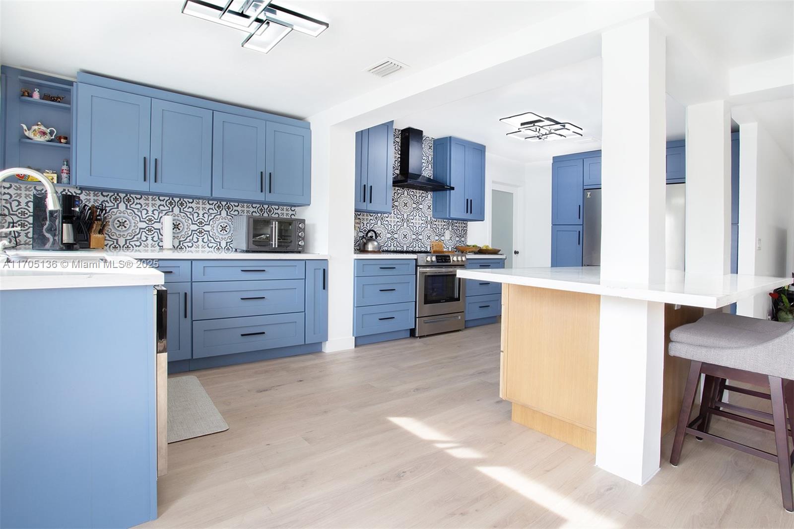 808 Mission Hill Road Boynton Beach, FL 33435 - Photo 21 of 68 a kitchen with stainless steel appliances a stove top oven a sink a refrigerator and cabinets