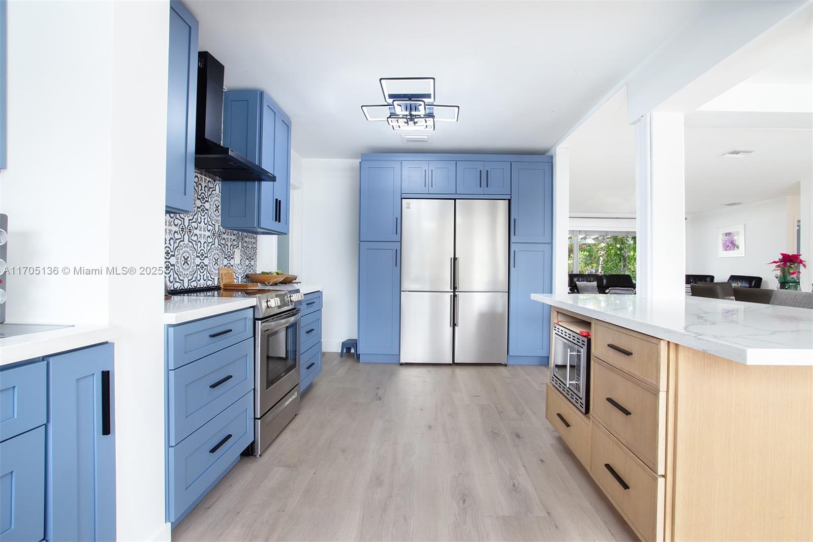 808 Mission Hill Road Boynton Beach, FL 33435 - Photo 22 of 68 a kitchen with stainless steel appliances a refrigerator sink and cabinets