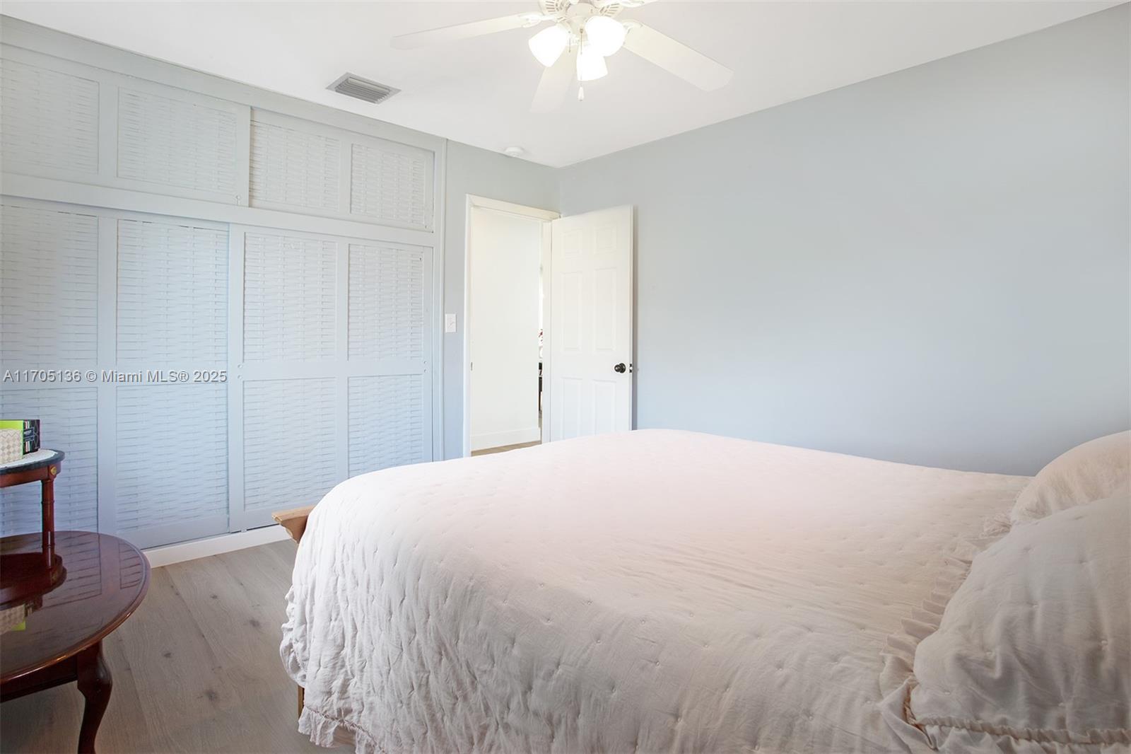 808 Mission Hill Road Boynton Beach, FL 33435 - Photo 28 of 68 a bedroom with a bed and a chandelier
