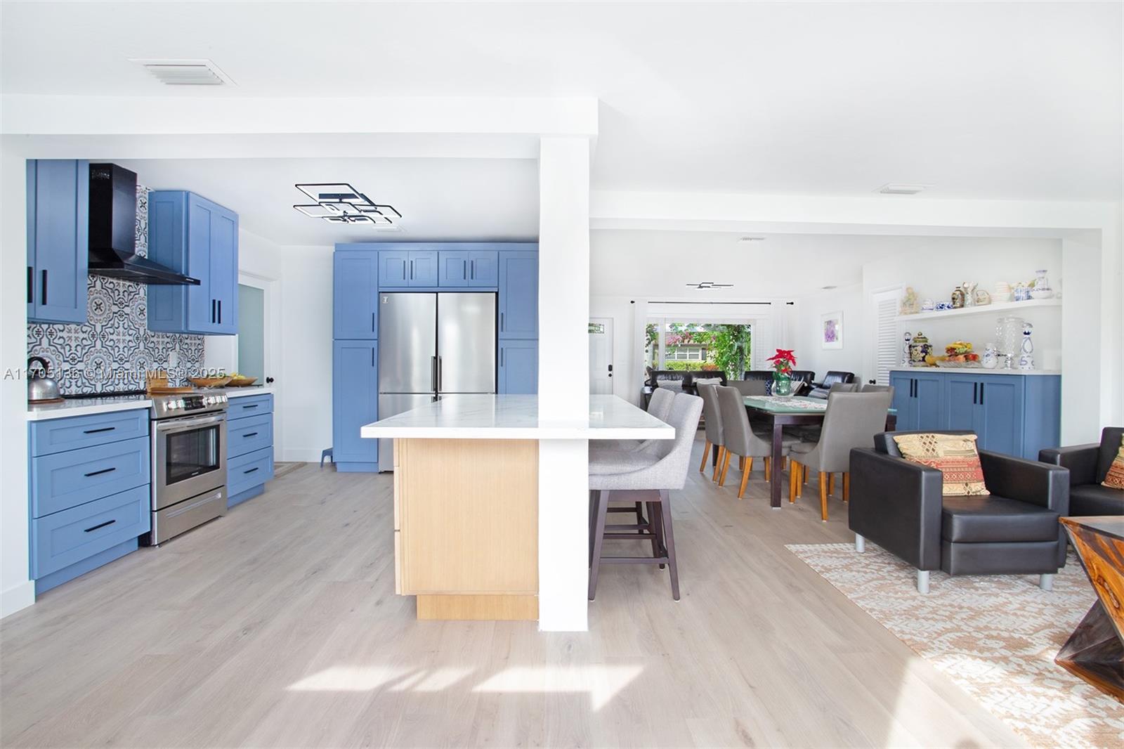 808 Mission Hill Road Boynton Beach, FL 33435 - Photo 3 of 68 a living room with furniture a dining table and kitchen view
