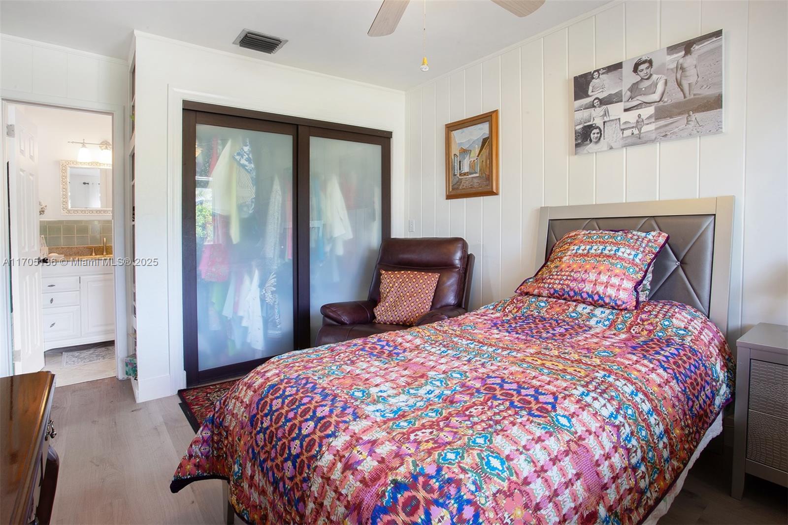 808 Mission Hill Road Boynton Beach, FL 33435 - Photo 35 of 68 a bedroom with a large bed and a chandelier