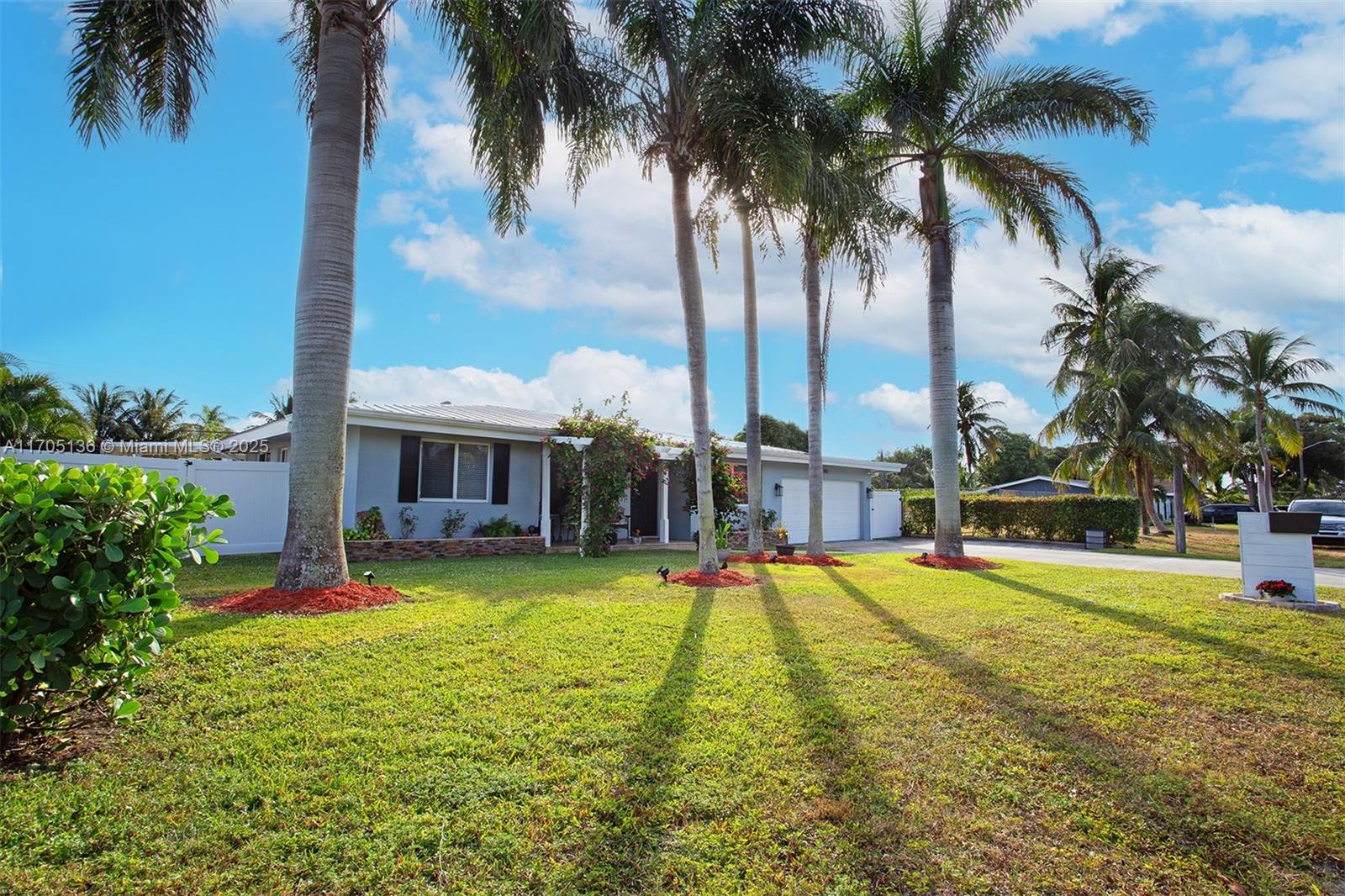 808 Mission Hill Road Boynton Beach, FL 33435 - Photo 57 of 68 a view of a swimming pool with a garden and palm trees