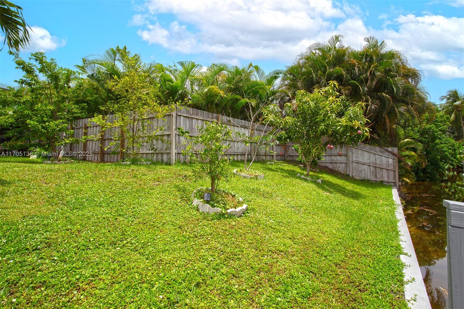 808 Mission Hill Road Boynton Beach, FL 33435 - Photo 60 of 68 a garden with trees in the background