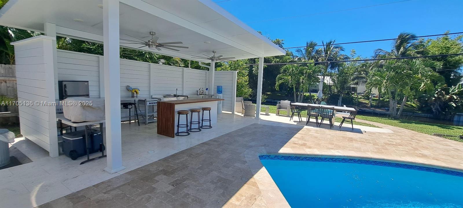808 Mission Hill Road Boynton Beach, FL 33435 - Photo 68 of 68 a view of a patio with couches chairs potted plants and palm tree