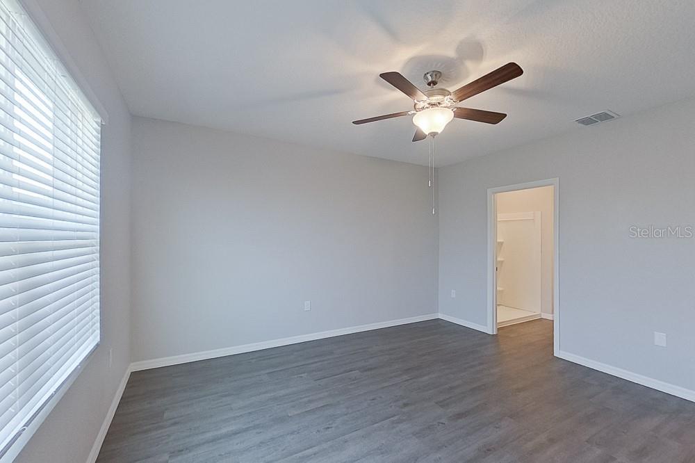 32044 Katelin Circle Leesburg, FL 34748 - Photo 14 of 20 wooden floor in an empty room with a window
