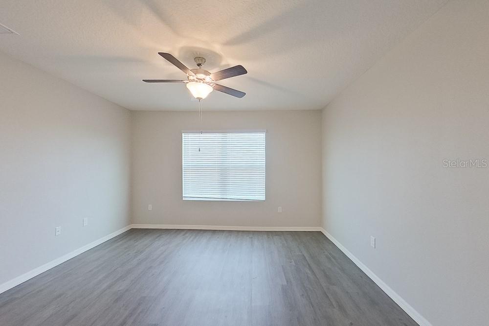 32044 Katelin Circle Leesburg, FL 34748 - Photo 15 of 20 wooden floor in an empty room with a window