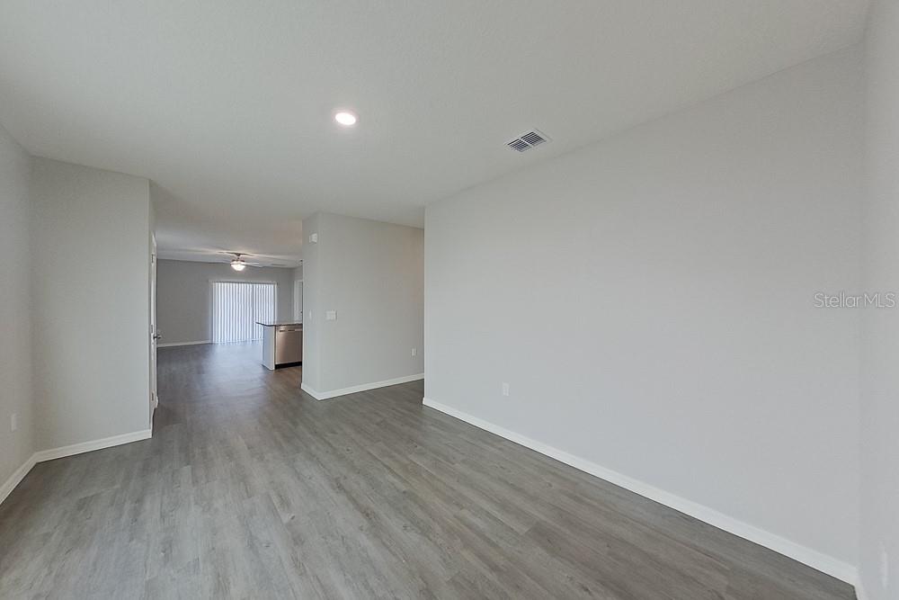 32044 Katelin Circle Leesburg, FL 34748 - Photo 3 of 20 a view of a big room with wooden floor and windows