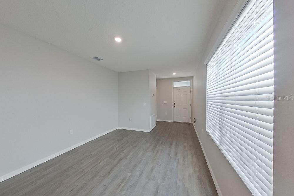 32044 Katelin Circle Leesburg, FL 34748 - Photo 4 of 20 a view of a hallway with wooden floor