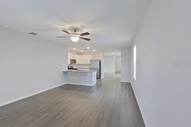 a view of kitchen with wooden floor and a kitchen