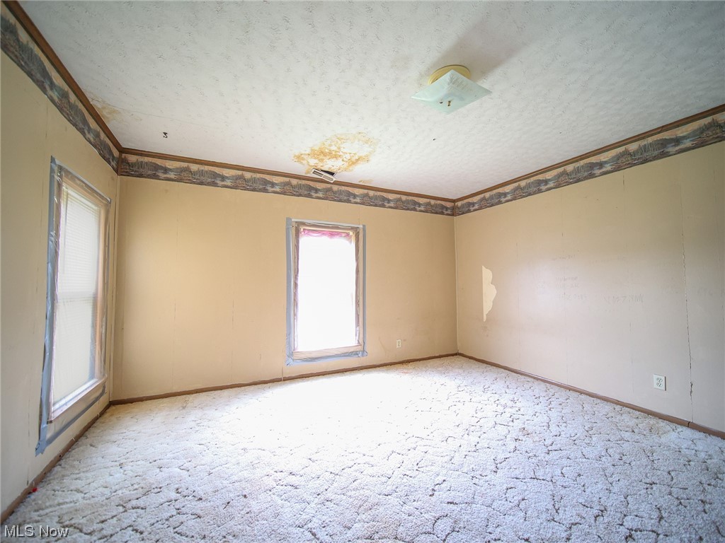 12432 Glasgow Road Southwest Port Washington, OH 43837 - Photo 31 of 31 Carpeted spare room with a textured ceiling