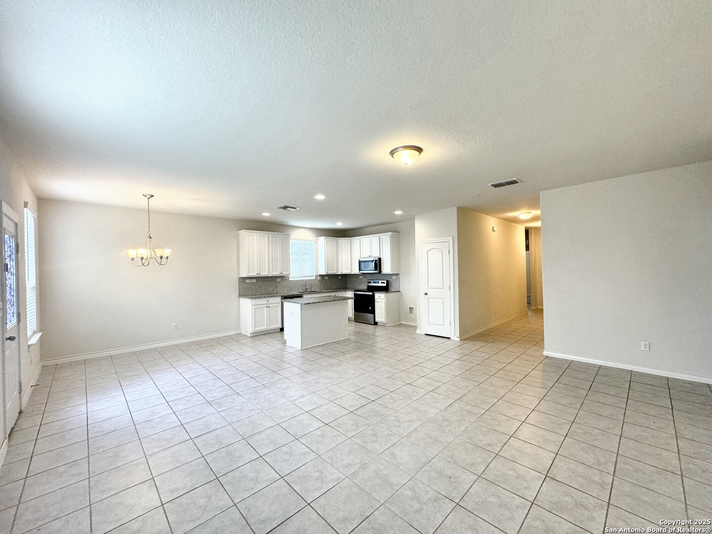2858 Ridge Berry Road New Braunfels, TX 78130 - Photo 16 of 19 an empty room with kitchen view and appliances