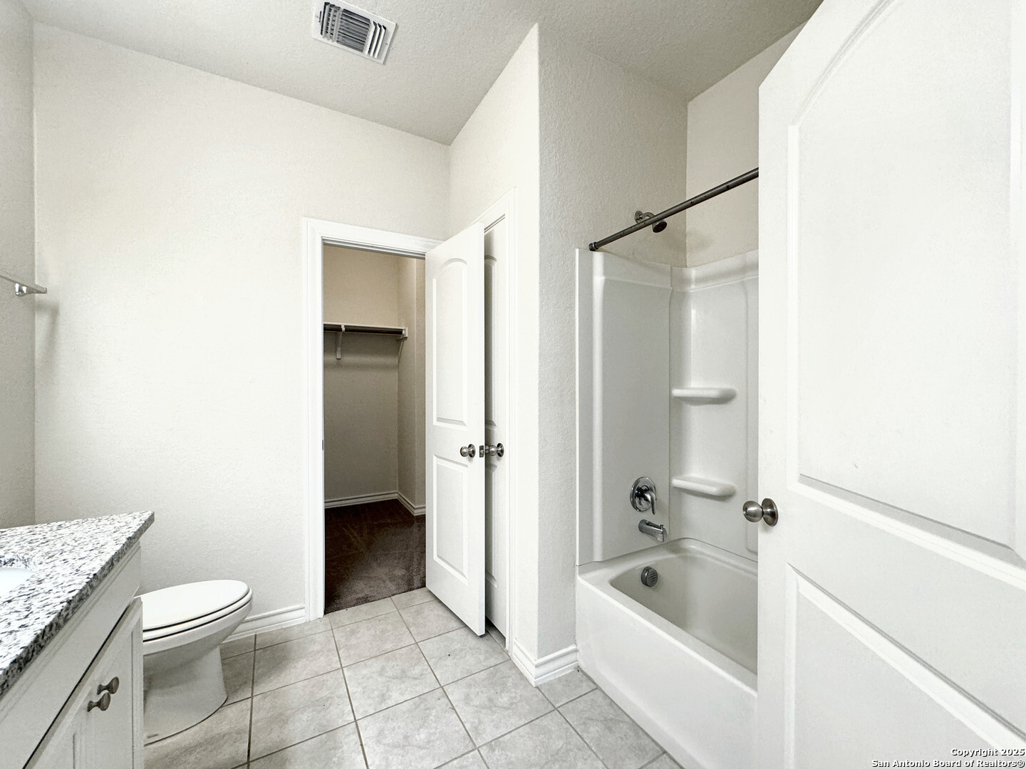 2858 Ridge Berry Road New Braunfels, TX 78130 - Photo 3 of 19 a bathroom with a granite countertop bathtub shower sink and toilet