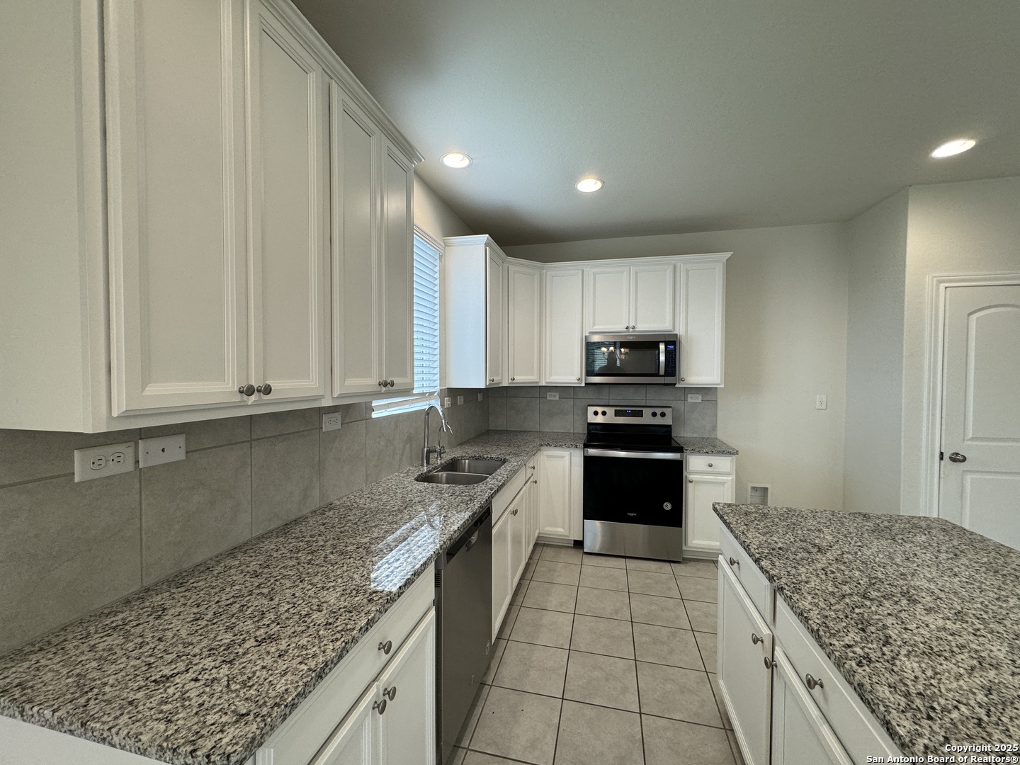 2858 Ridge Berry Road New Braunfels, TX 78130 - Photo 5 of 19 a kitchen with granite countertop a stove sink and cabinets
