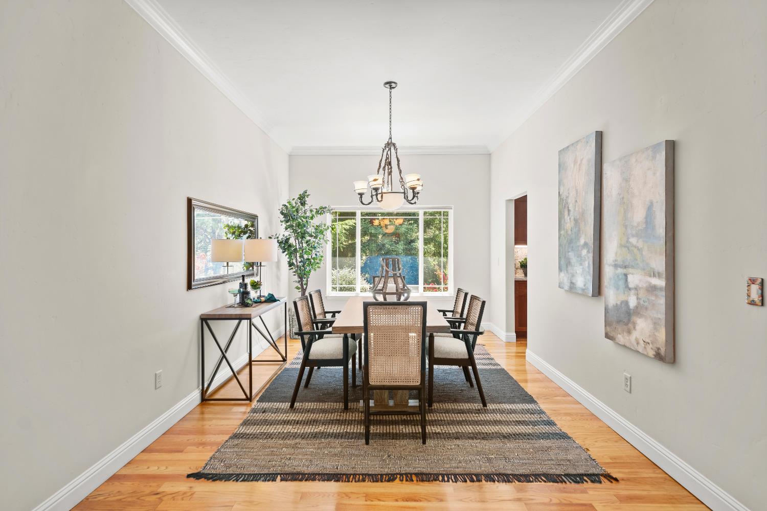 943 Eden Valley Road Colfax, CA 95713 - Photo 16 of 82 a dining room with wooden floor a rug a potted plant and windows
