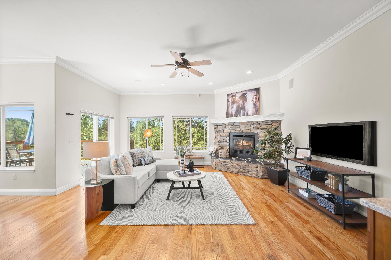 943 Eden Valley Road Colfax, CA 95713 - Photo 18 of 82 a living room with fireplace furniture flat screen tv and large windows