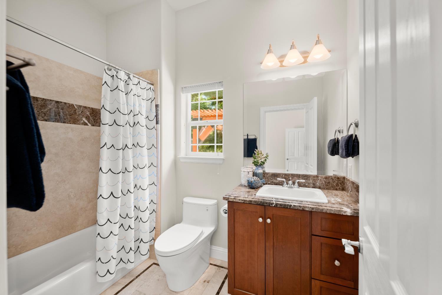 943 Eden Valley Road Colfax, CA 95713 - Photo 53 of 82 a bathroom with a sink a toilet a mirror a vanity and shower