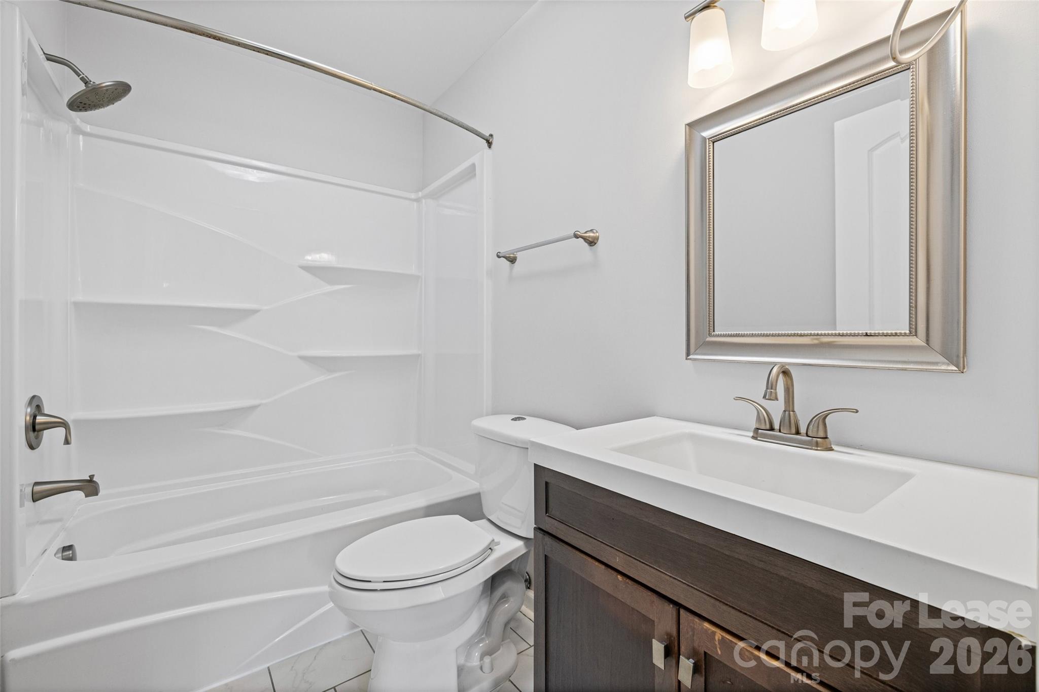 113 Stroupe Road, Unit E Gastonia, NC 28056 - Photo 21 of 33 a bathroom with a sink a toilet and shower