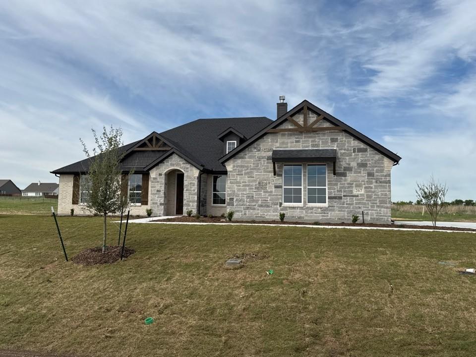267 Mdw Vista Drive Rhome, TX 76078 - Photo 1 of 13 a front view of a house with a yard