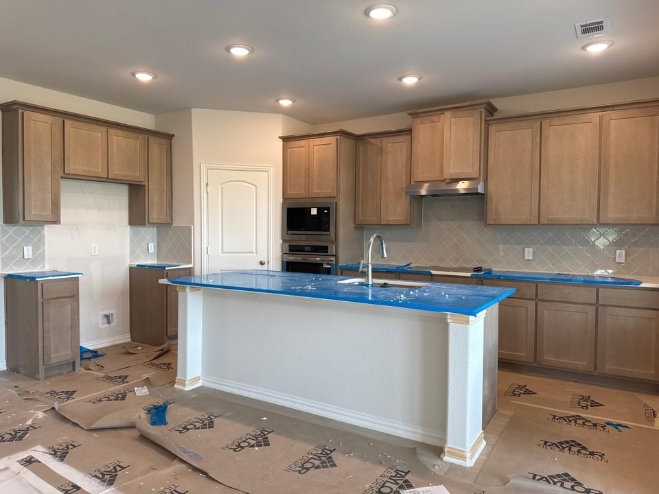 267 Mdw Vista Drive Rhome, TX 76078 - Photo 11 of 13 a kitchen with stainless steel appliances granite countertop a sink refrigerator and cabinets