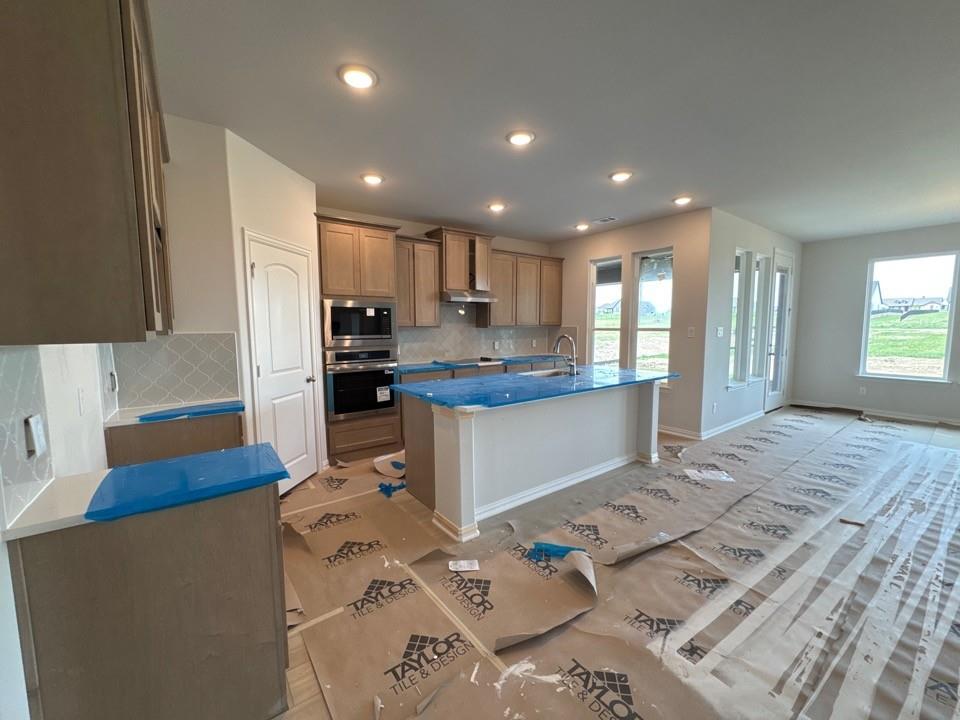 267 Mdw Vista Drive Rhome, TX 76078 - Photo 9 of 13 a kitchen with stainless steel appliances granite countertop a refrigerator sink and cabinets