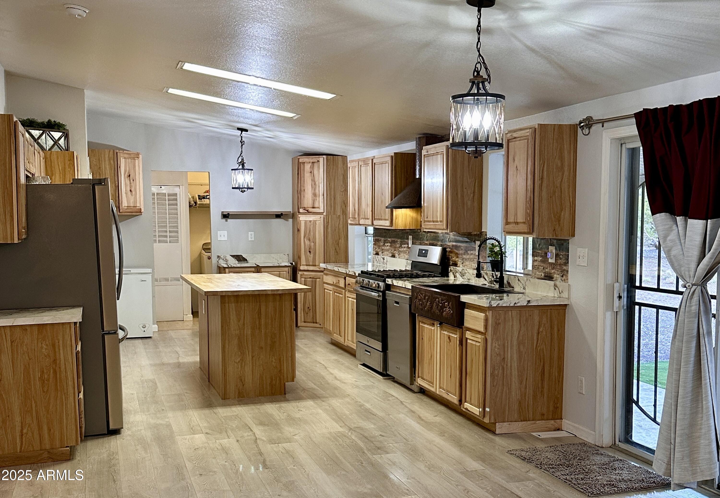 80 Acr 8050 Road Concho, AZ 85924 - Photo 11 of 30 a kitchen with kitchen island a counter top space stainless steel appliances and cabinets