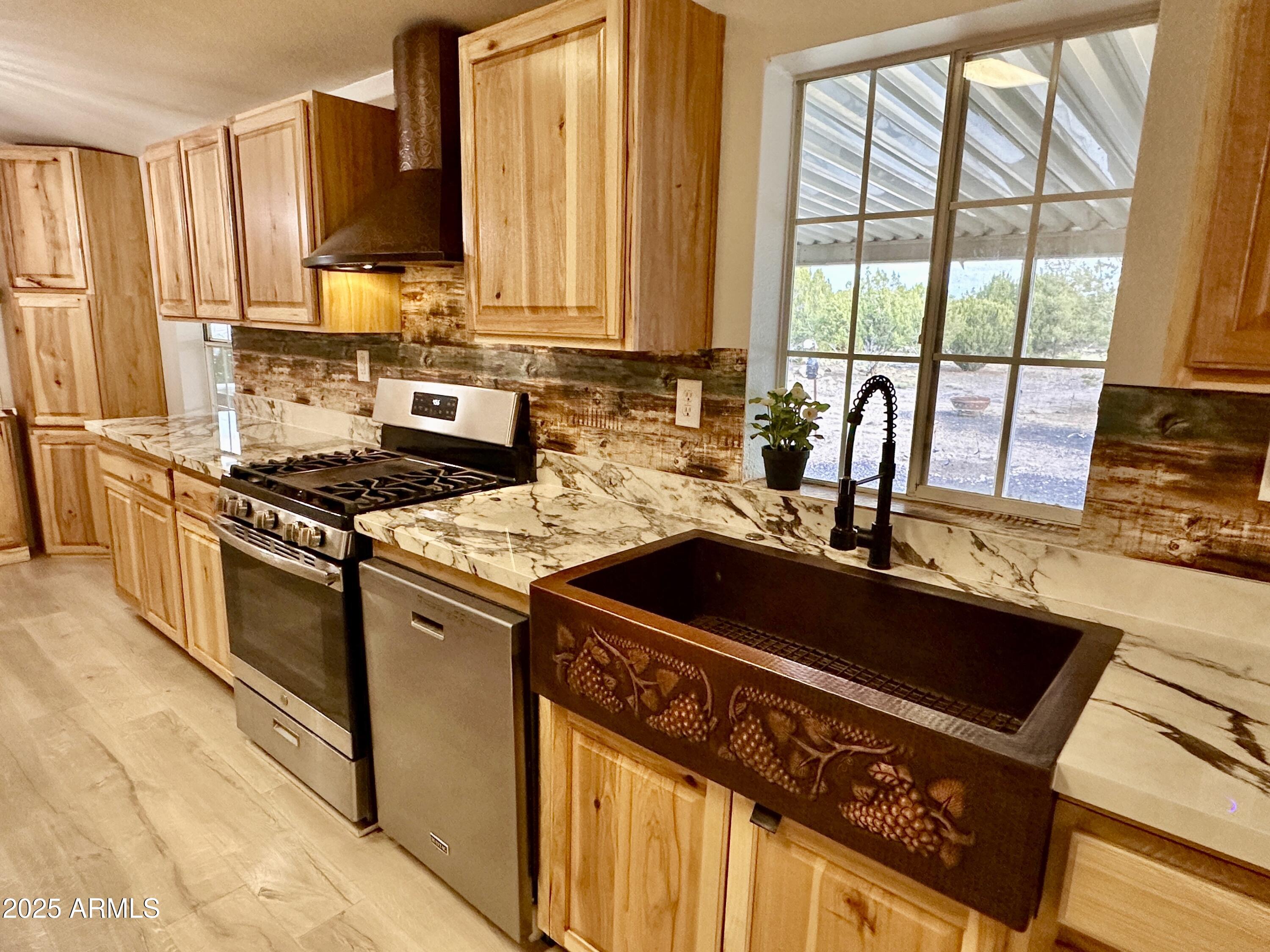 80 Acr 8050 Road Concho, AZ 85924 - Photo 14 of 30 a kitchen with stainless steel appliances a sink stove and cabinets