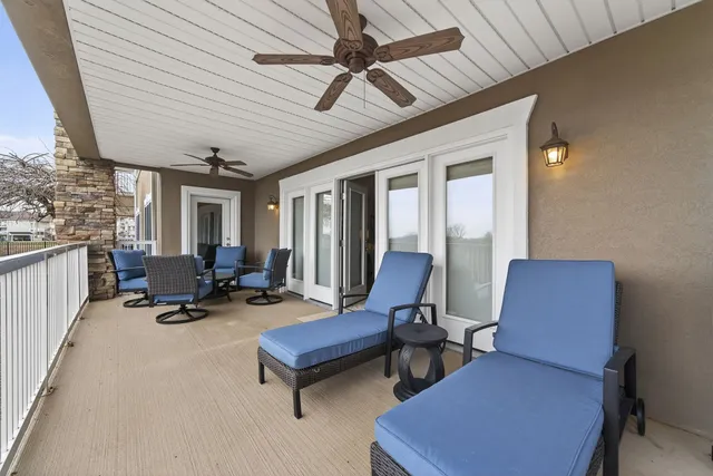 a living room with furniture a rug and a chandelier
