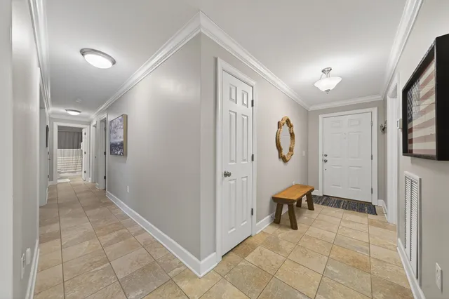 a view of a hallway with closet and bathroom