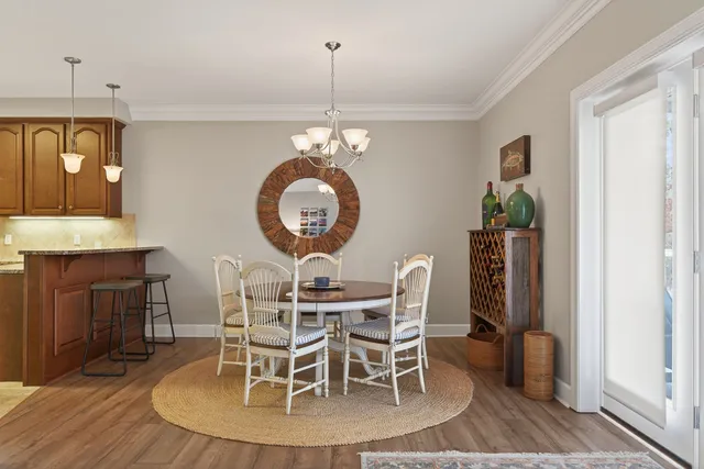 a view of a dining room with furniture and chandelier