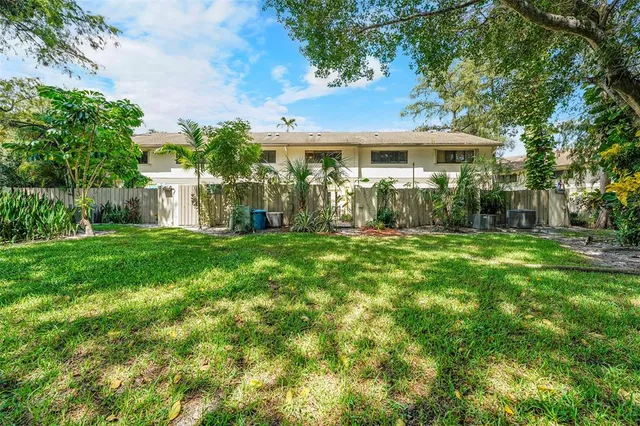 a front view of a house with yard and green space