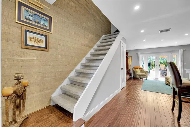 a view of a hallway with wooden floor and staircase