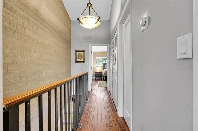 a bed sitting in a spacious bedroom next to a window