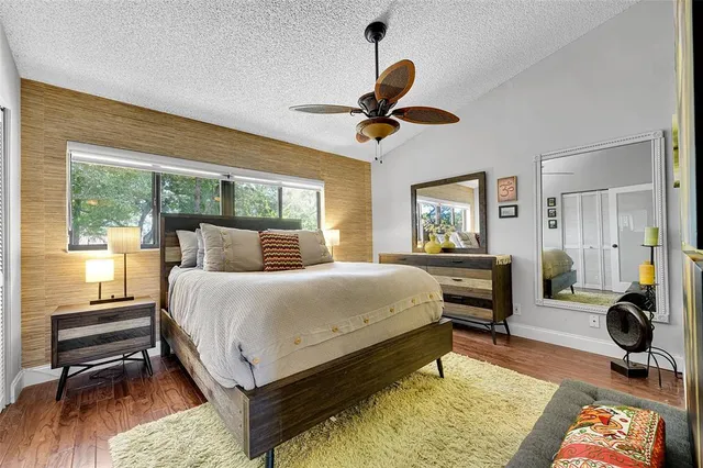 a bed room with a bed and a fan