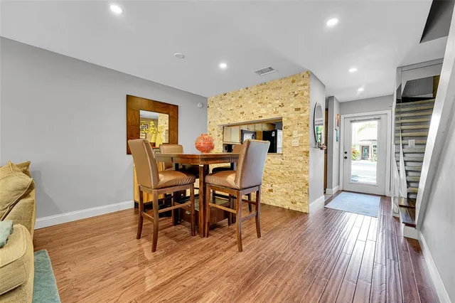 a view of a dining room with furniture and wooden floor