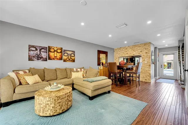 a living room with furniture and wooden floor
