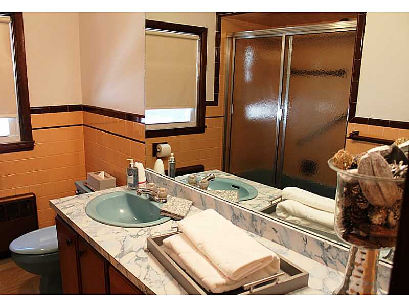435 Budlong Road Cranston, RI 02920 - Photo 12 of 21 Bathroom. Bathroom features tile tub with shower and linen closet with laundry shoot. Cool!