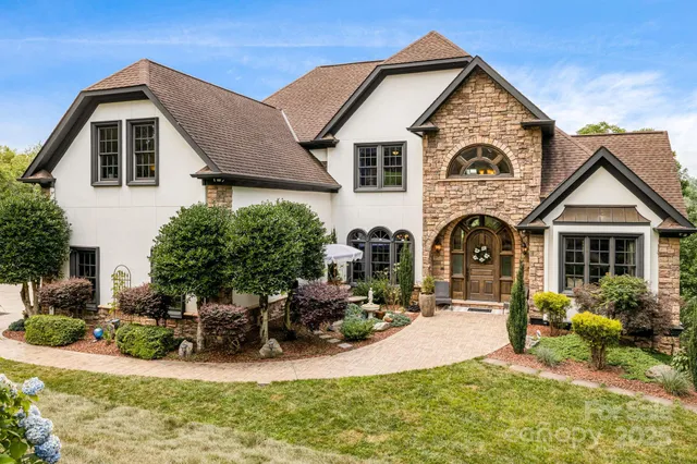a view of a house with yard and sitting area