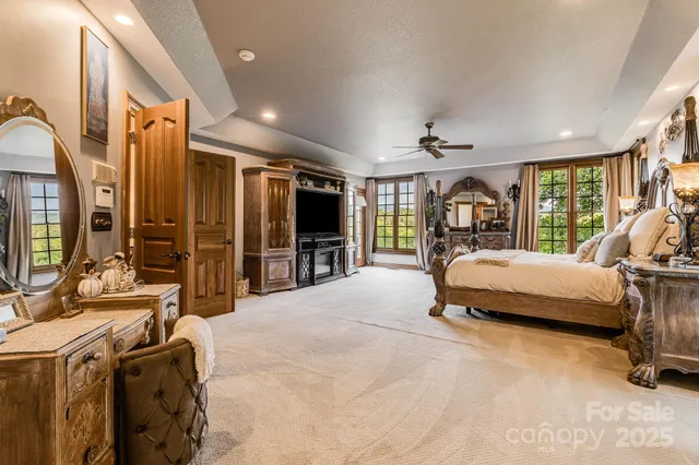 a bedroom with furniture and a flat screen tv
