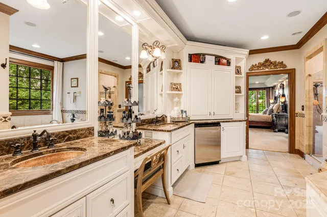 a large white kitchen with a large window