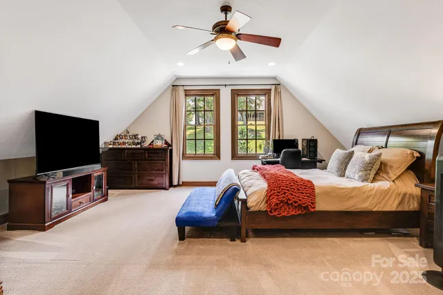 a bedroom with bed and flat screen tv