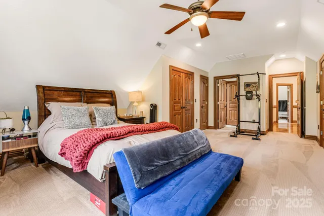 a bedroom with a bed and ceiling fan