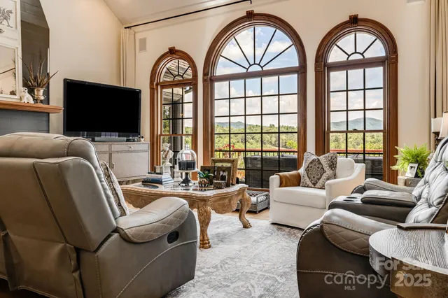 a living room with furniture fireplace and flat screen tv